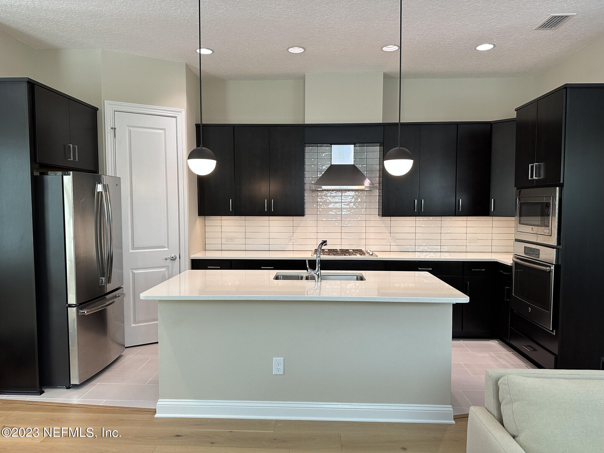 44 Rinaldo Way Ponte Vedra, FL 32081 - Photo 16 of 30 a large kitchen with a large counter top stainless steel appliances and cabinets