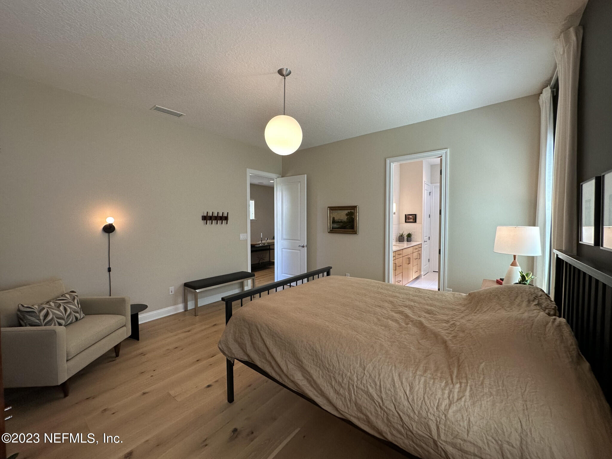 44 Rinaldo Way Ponte Vedra, FL 32081 - Photo 20 of 30 a spacious bedroom with a bed and a chandelier