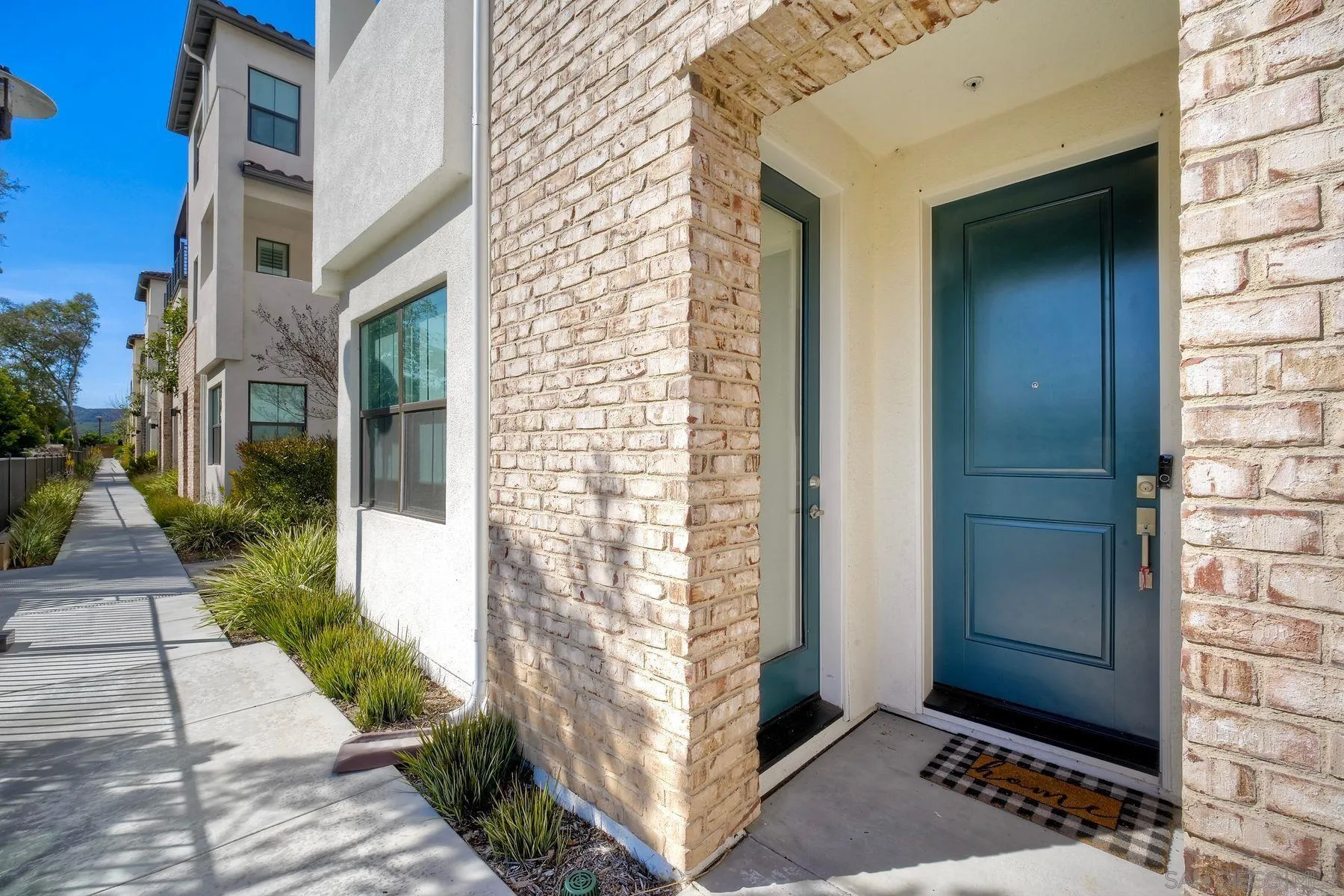 13087 Olympus Circle, Unit 2 Poway, CA 92064 - Photo 2 of 29 a view of a brick house with a street