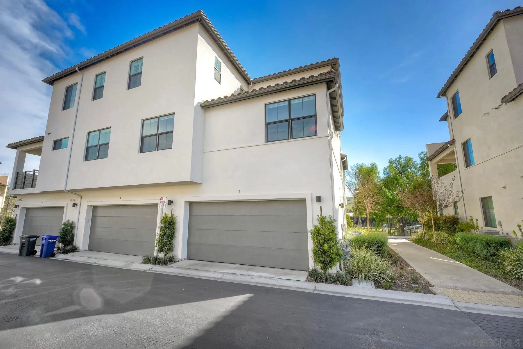 13087 Olympus Circle, Unit 2 Poway, CA 92064 - Photo 25 of 29 a front view of a house with a yard and garage