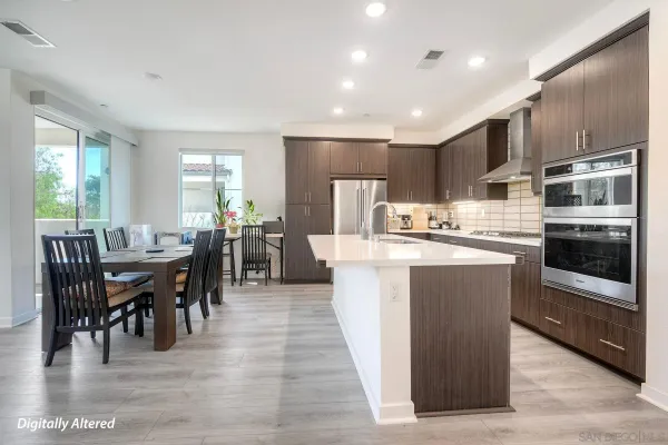 a large kitchen with kitchen island a sink a counter space and stainless steel appliances