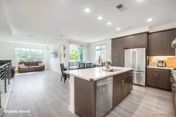 a kitchen with stainless steel appliances granite countertop a sink a stove and a refrigerator