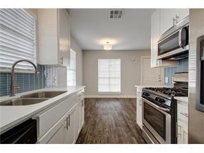 6205 Hyside Drive, Unit B Austin, TX 78723 - Photo 2 of 3 a kitchen with stainless steel appliances granite countertop a sink stove and cabinets