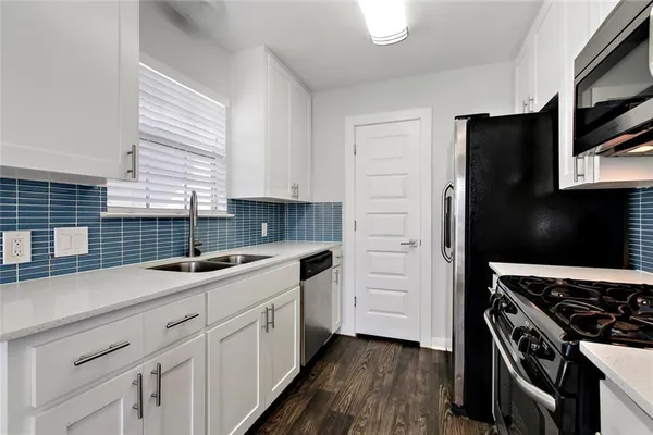 a kitchen with a sink stove and refrigerator