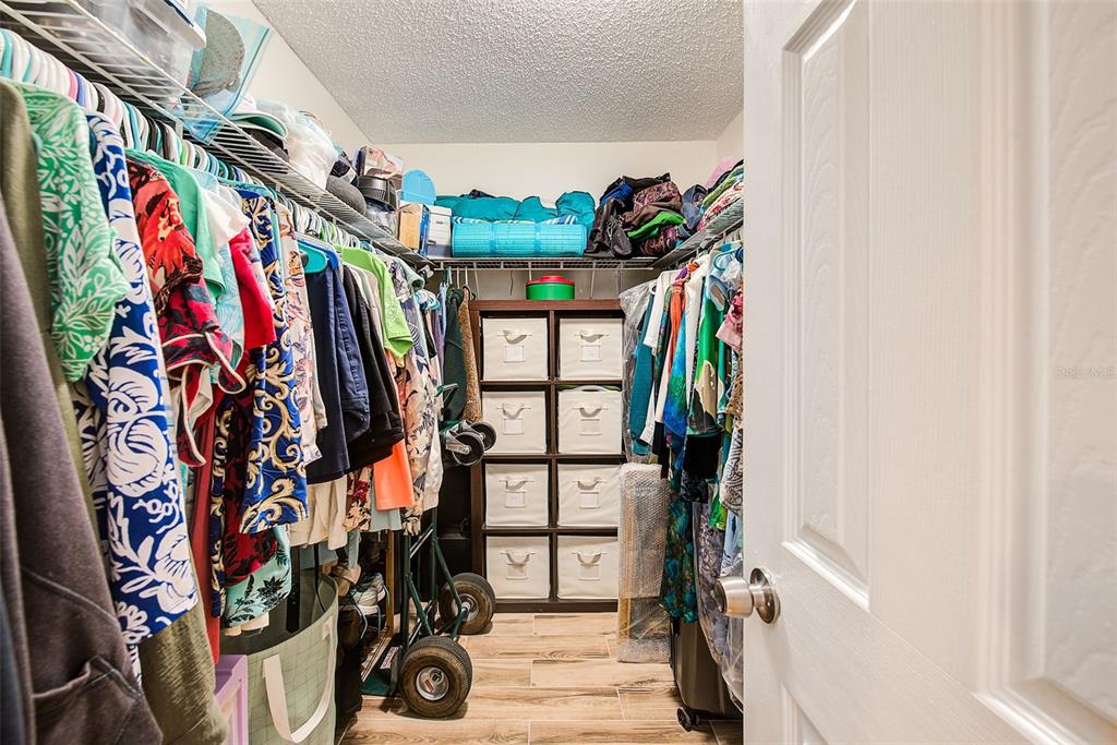 2064 Sunset Point Road, Unit 73 Clearwater, FL 33765 - Photo 27 of 58 a view of walk in closet with clothes