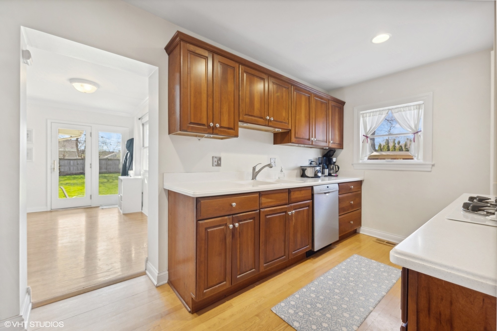 920 Sunset Road Wheaton, IL 60189 - Photo 8 of 27 a kitchen with stainless steel appliances granite countertop wooden cabinets a stove a sink and a large window