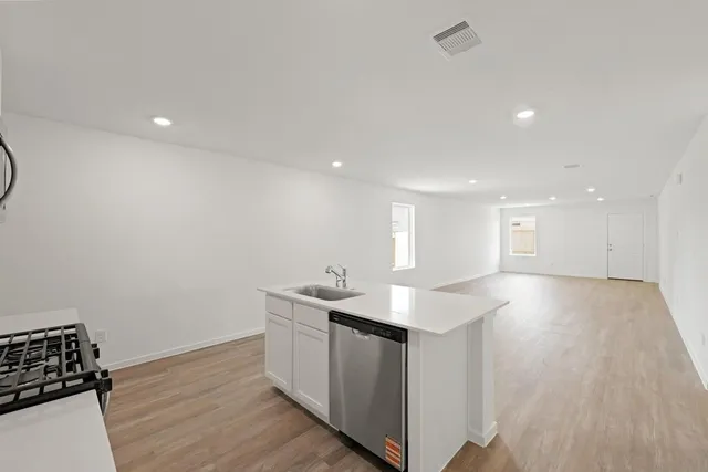 a kitchen with a sink and cabinets