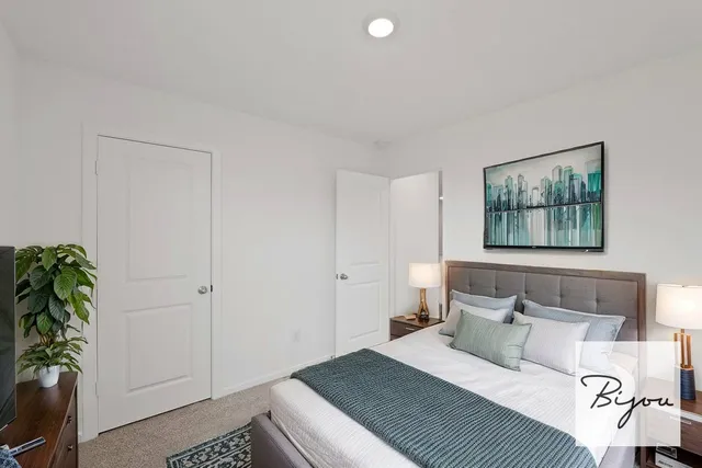 a bedroom with a bed and a potted plant