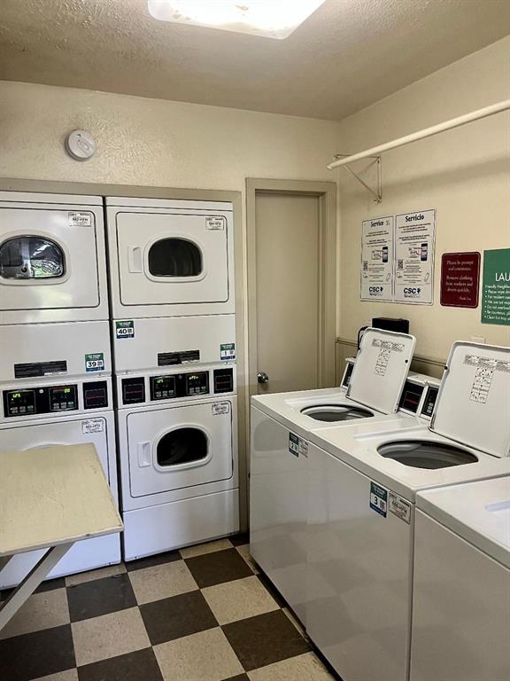 4859 Cedar Springs Road, Unit 358 Dallas, TX 75219 - Photo 12 of 12 Shared laundry featuring a textured ceiling and separate washer and dryer