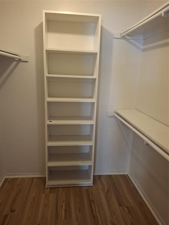 4859 Cedar Springs Road, Unit 358 Dallas, TX 75219 - Photo 3 of 12 Spacious closet with dark wood-style floors
