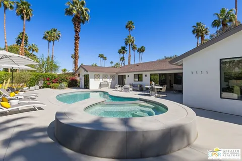a view of a house with swimming pool and sitting area