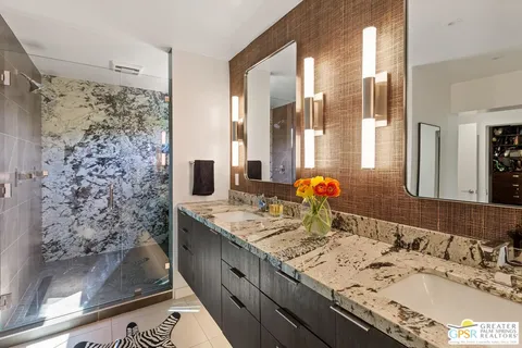 a bedroom with a bed and a lamp on dresser