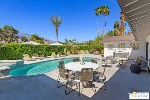 an outdoor space with swimming pool and furniture