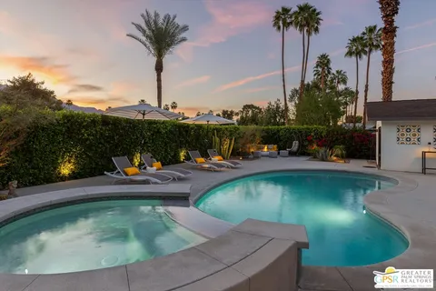 a view of yard with swimming pool and green space