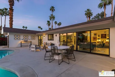 a view of a patio with swimming pool table and chairs