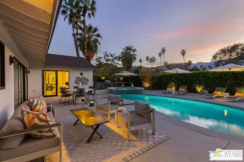a view of a patio with table and chairs and potted plants