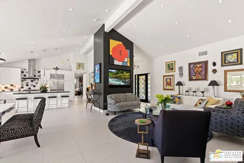 a living room with fireplace furniture and a flat screen tv