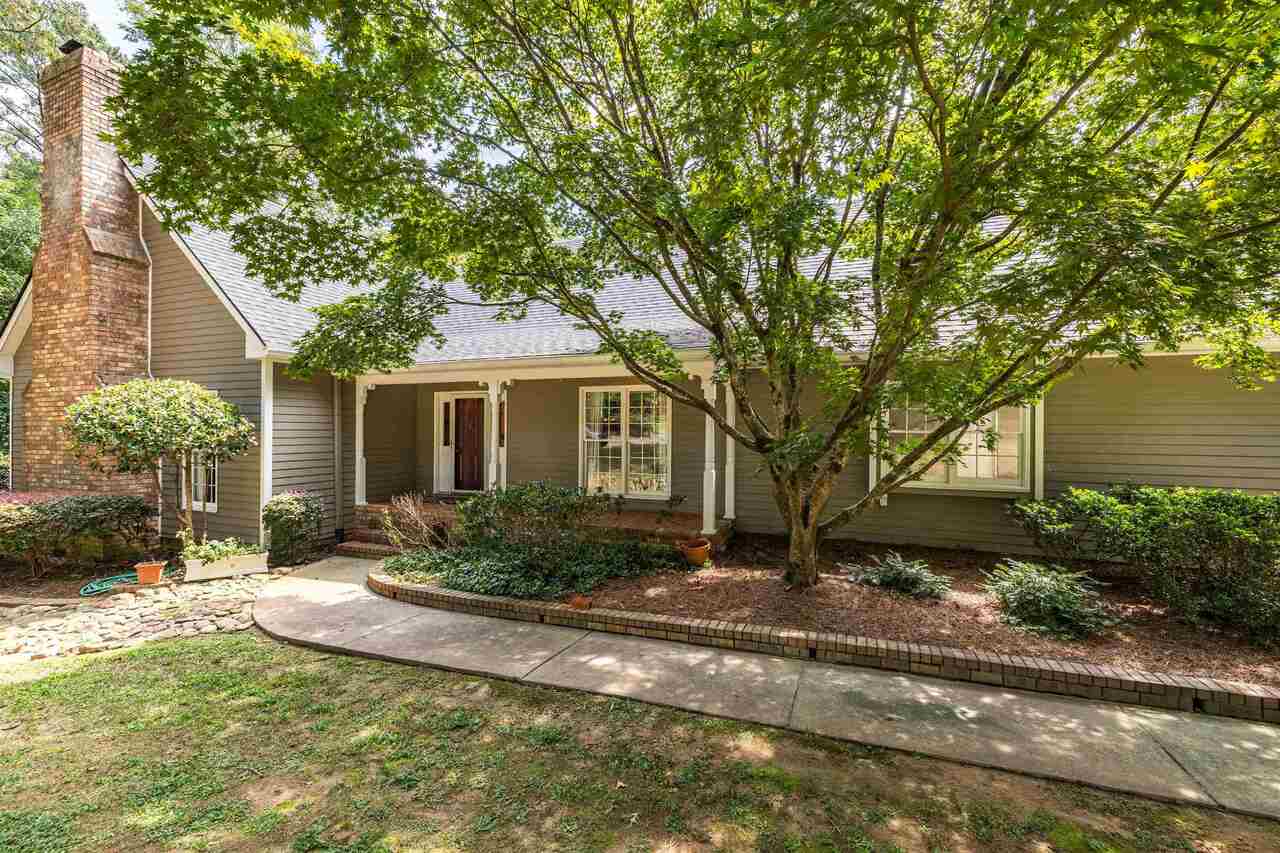 27 Huntington Road Southwest Rome, GA 30165 - Photo 1 of 1 a front view of a house with a yard and potted plants
