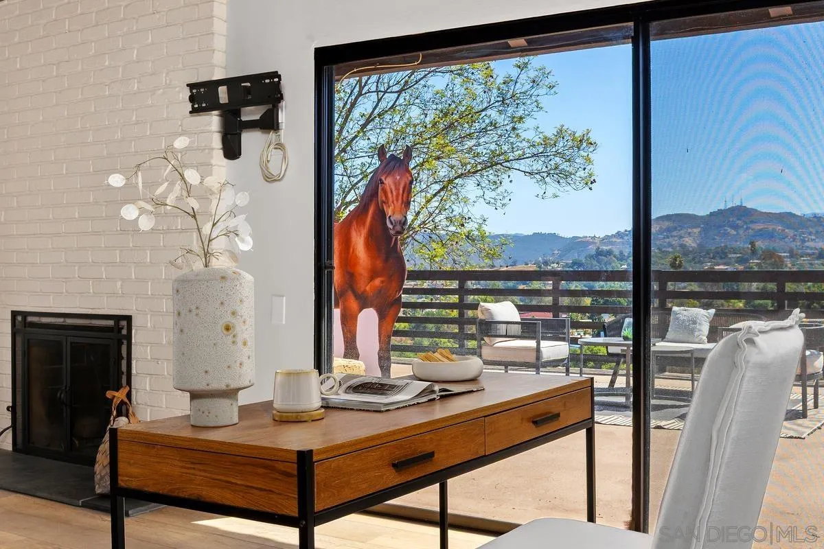 974 Via Hillview Fallbrook, CA 92028 - Photo 12 of 43 a living room with fireplace furniture and a floor to ceiling window