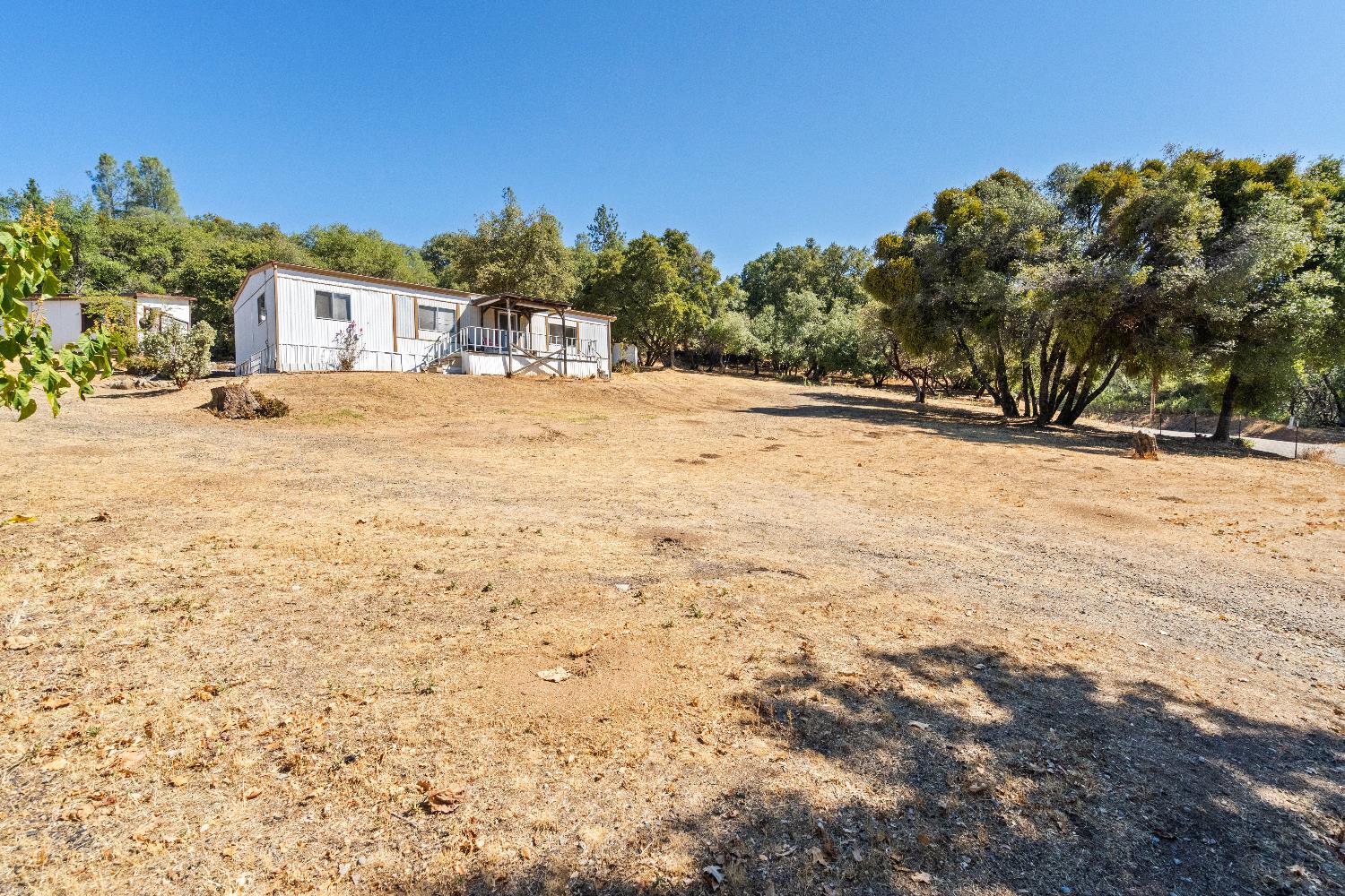 a view of white house with a yard
