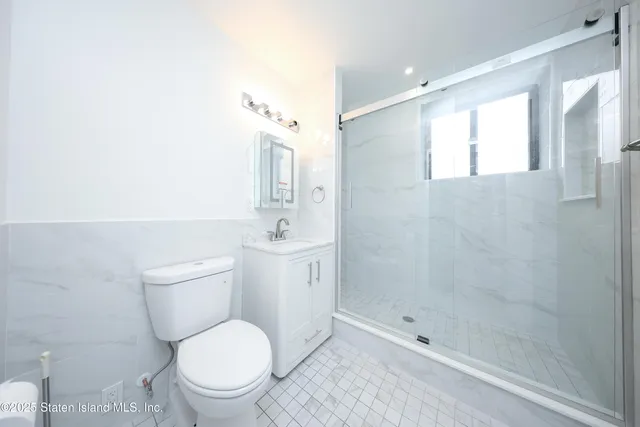 a bathroom with a toilet sink and shower