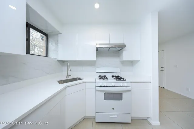 a kitchen with a stove and a sink