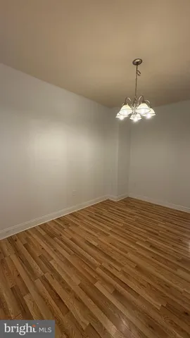 a view of a room with wooden floor and fan