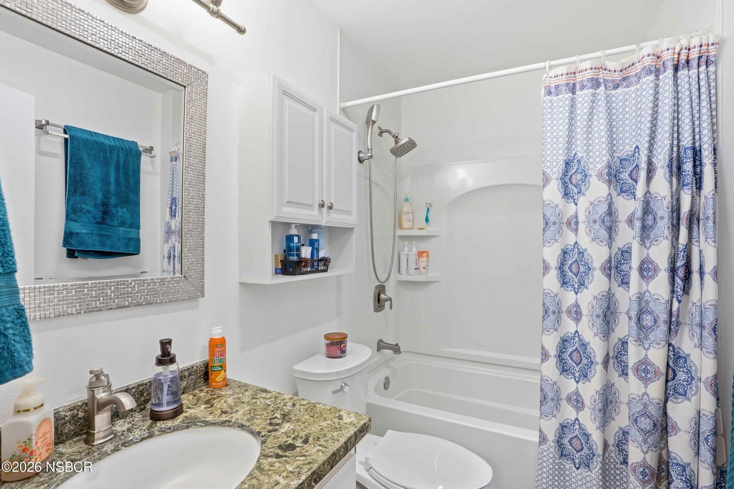 218 North R Street Lompoc, CA 93436 - Photo 17 of 24 a bathroom with a sink toilet and shower