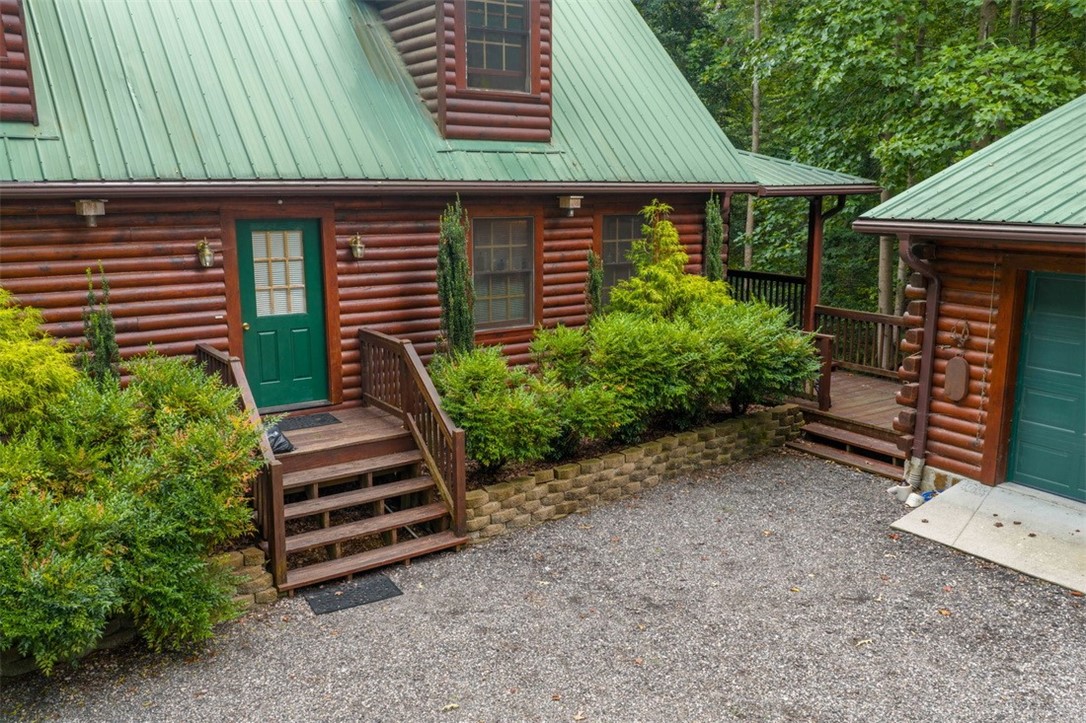 846 Twiggs Ferry Road Hartfield, VA 23071 - Photo 15 of 28 Doorway to property featuring a metal roof and log siding