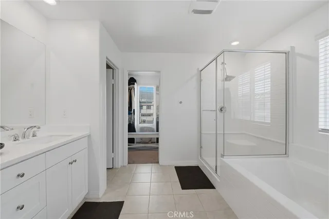 a bedroom with a bed and a computer on the desk