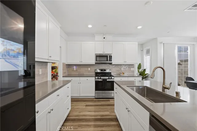 a kitchen with granite countertop a sink and cabinets
