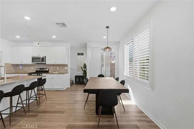 a living room with furniture and view of kitchen