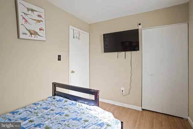 a bedroom with a bed and a television