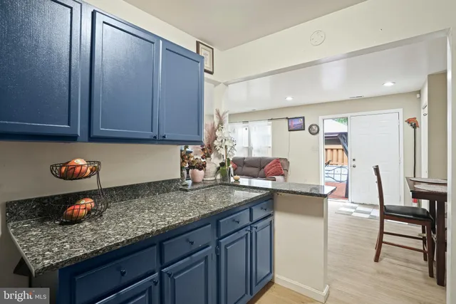 a kitchen with a sink a stove and cabinets