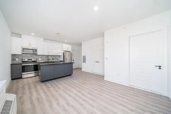 a view of an empty room and wooden floor