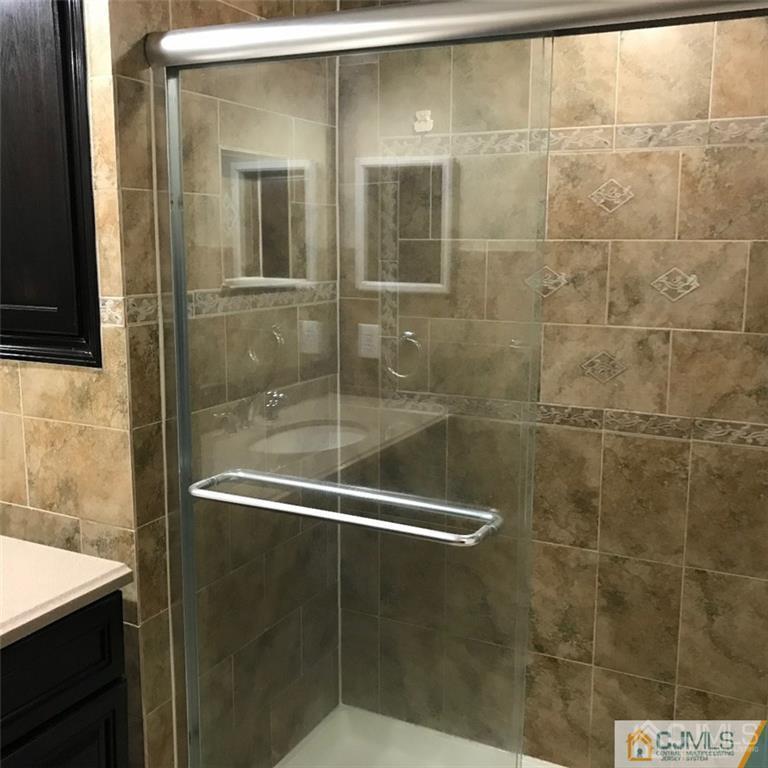 5108 Stonehedge Road Edison, NJ 08820 - Photo 4 of 6 a bathroom with a glass shower door