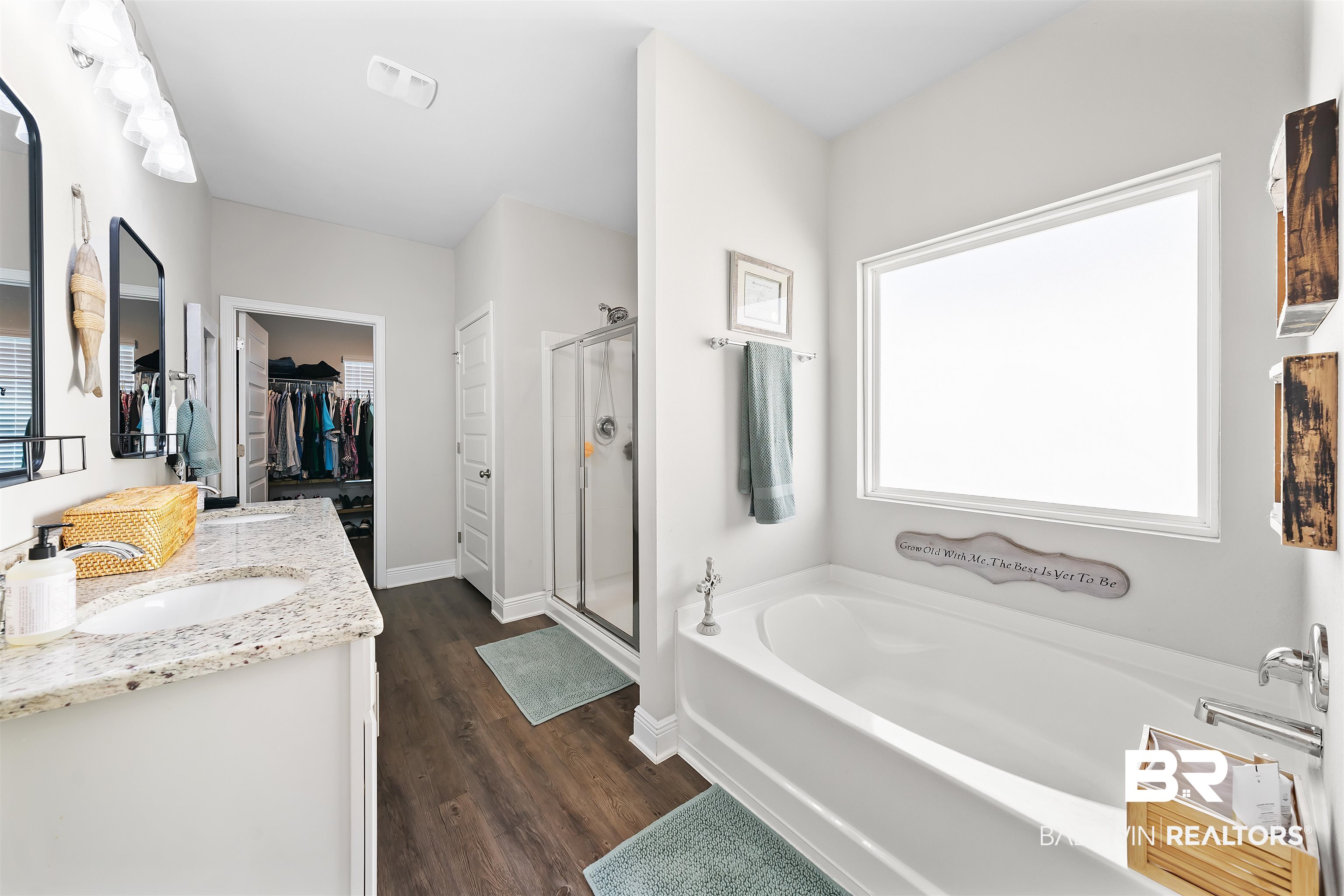 1221 Primrose Lane Foley, AL 36535 - Photo 12 of 29 Full bathroom featuring a walk in closet, a stall shower, a sink, wood finished floors, and a bath