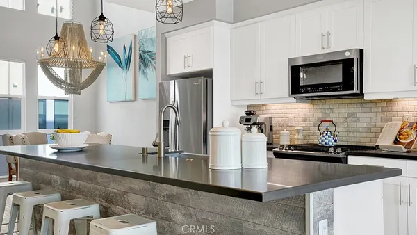 a kitchen with stainless steel appliances granite countertop a sink and a microwave