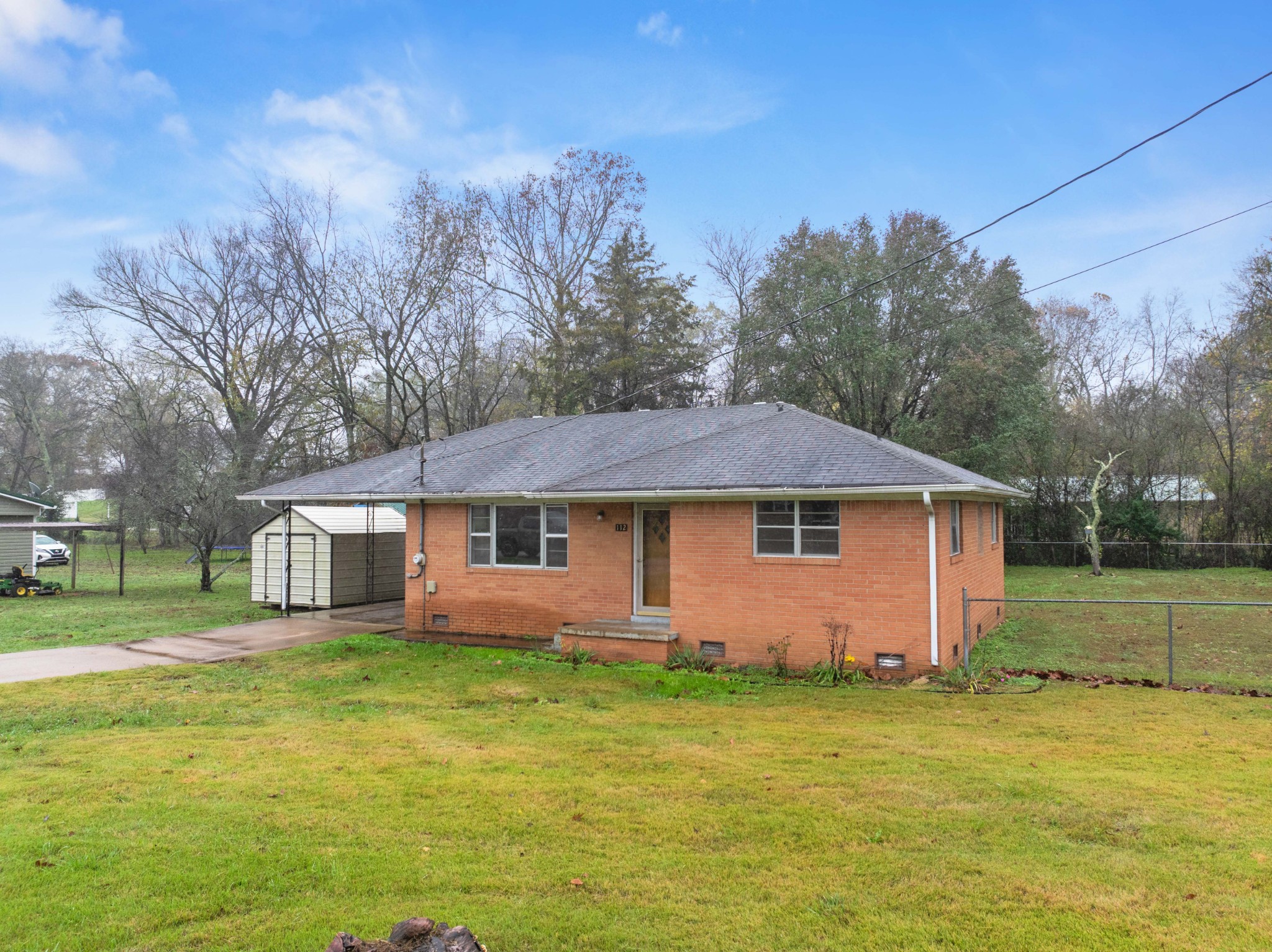 112 Brookside Drive Linden, TN 37096 - Photo 13 of 17 a front view of house with yard and trees in the background