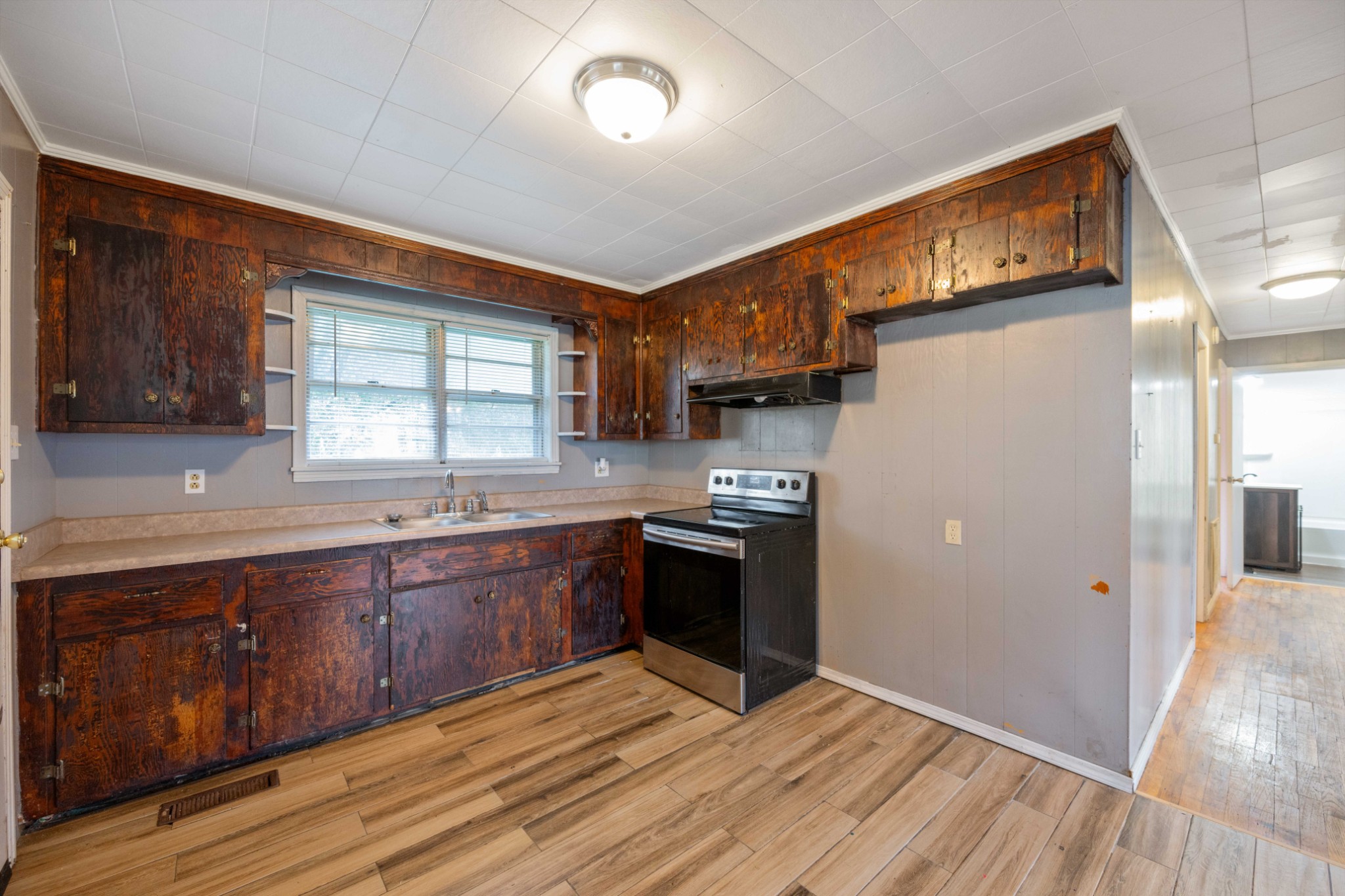 112 Brookside Drive Linden, TN 37096 - Photo 3 of 17 a kitchen with stainless steel appliances granite countertop a refrigerator a sink dishwasher a stove and white countertops with wooden floor