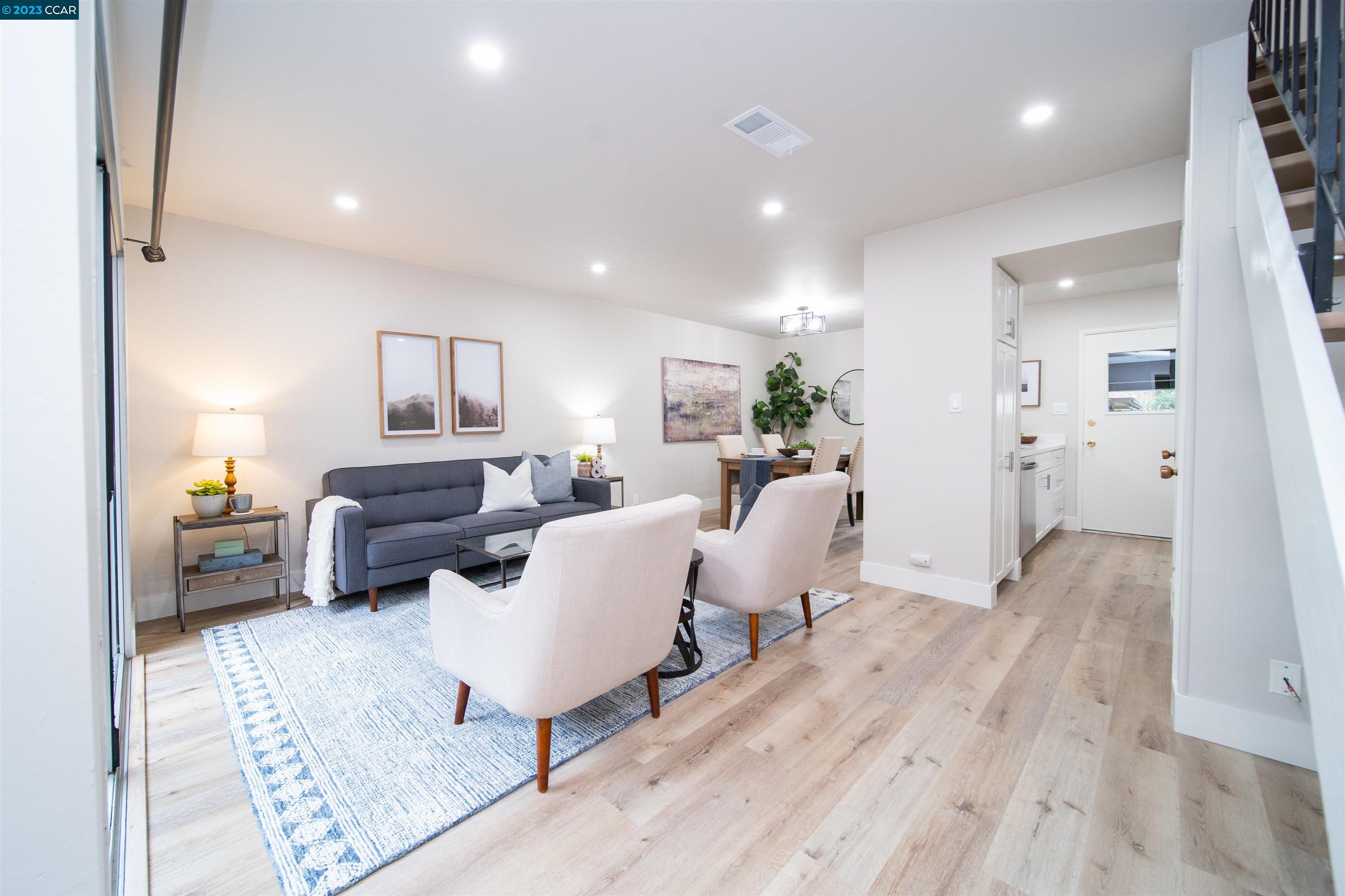 5501 Roundtree Drive, Unit E Concord, CA 94521 - Photo 1 of 1 a living room with furniture and a wooden floor
