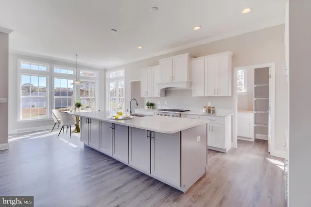 a kitchen with counter top space and wooden floor