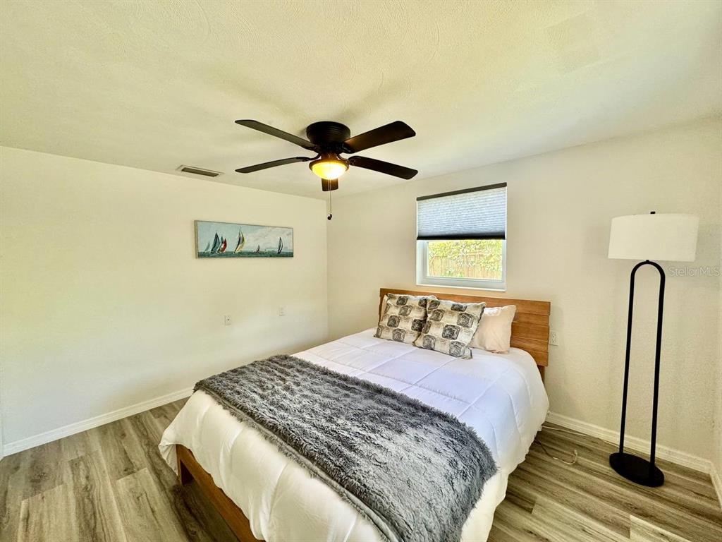 4282 Rudder Way New Port Richey, FL 34652 - Photo 19 of 34 a bedroom with a bed and a painting on the wall