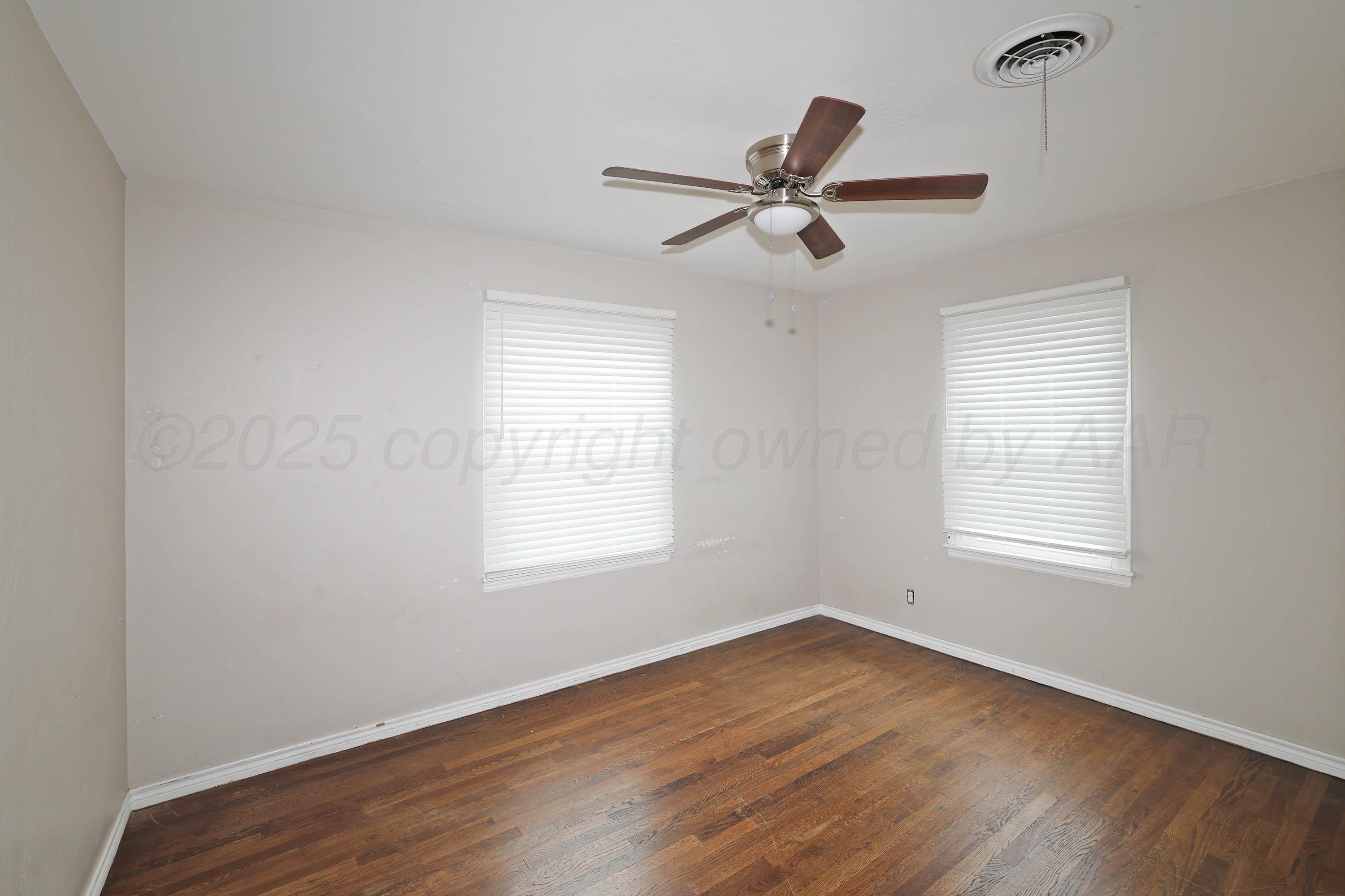 4112 South Tyler Street Amarillo, TX 79110 - Photo 14 of 20 a view of empty room with wooden floor and fan