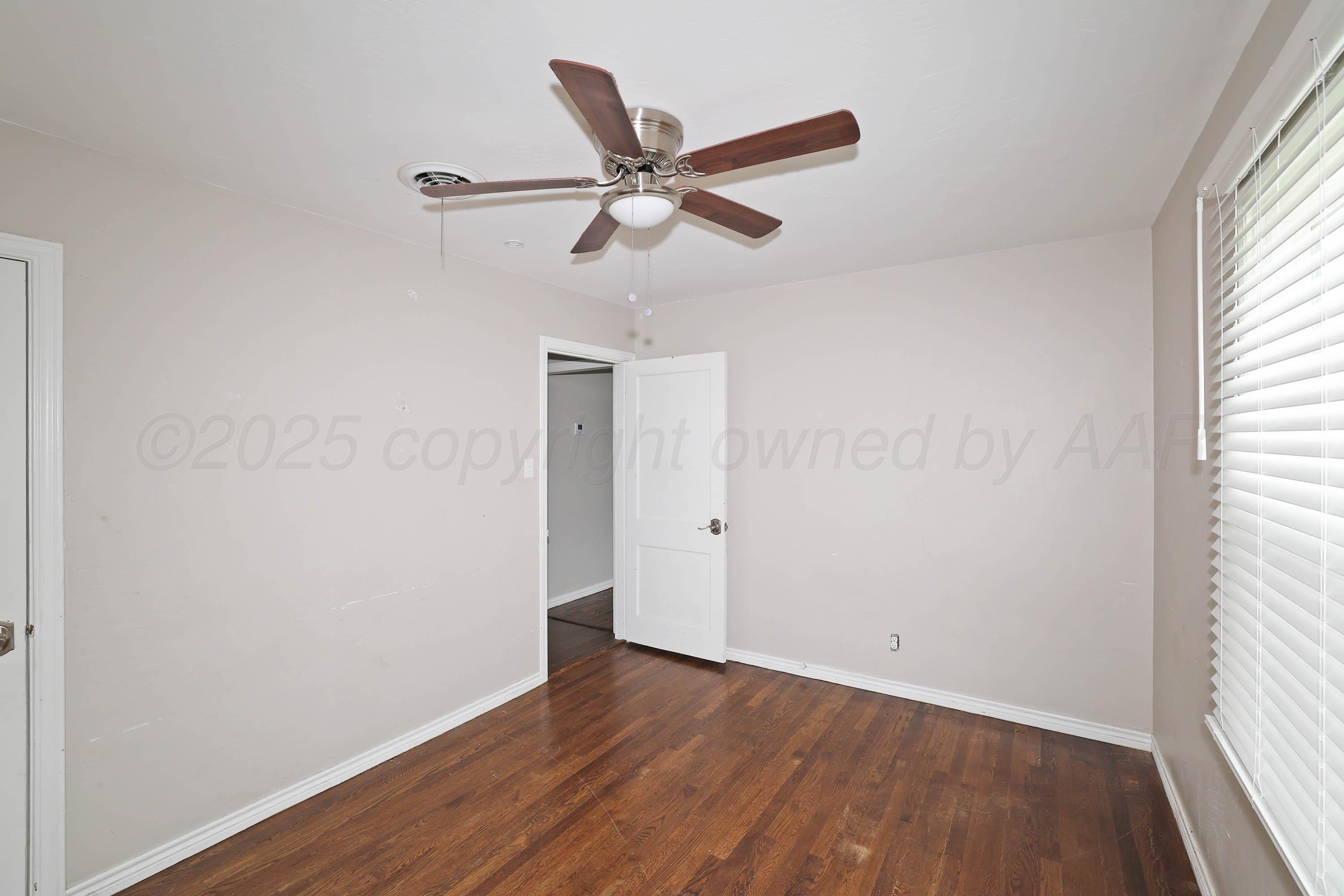 4112 South Tyler Street Amarillo, TX 79110 - Photo 15 of 20 a view of a room with wooden floor and ceiling fan