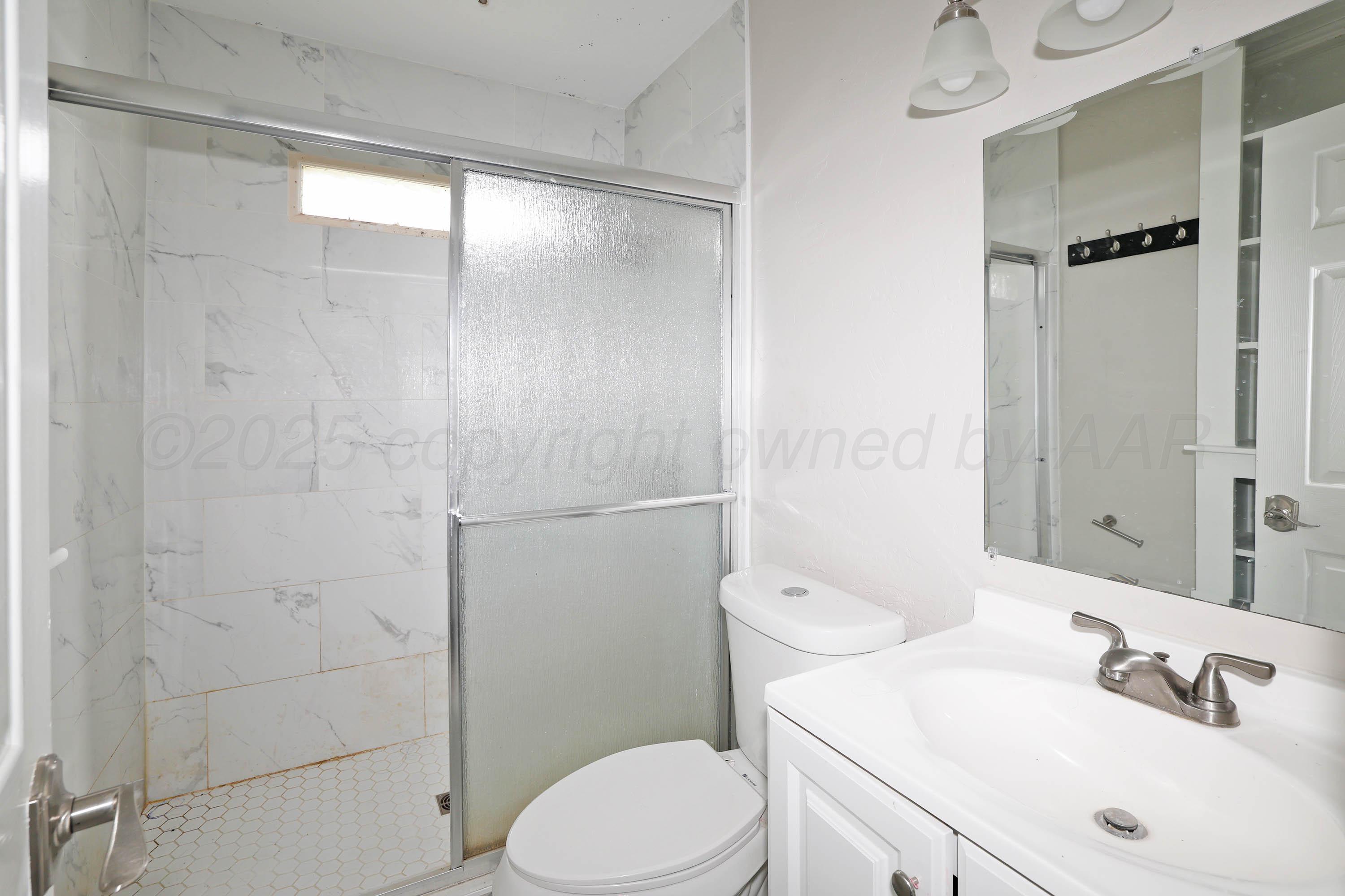 4112 South Tyler Street Amarillo, TX 79110 - Photo 16 of 20 a bathroom with a sink toilet and shower