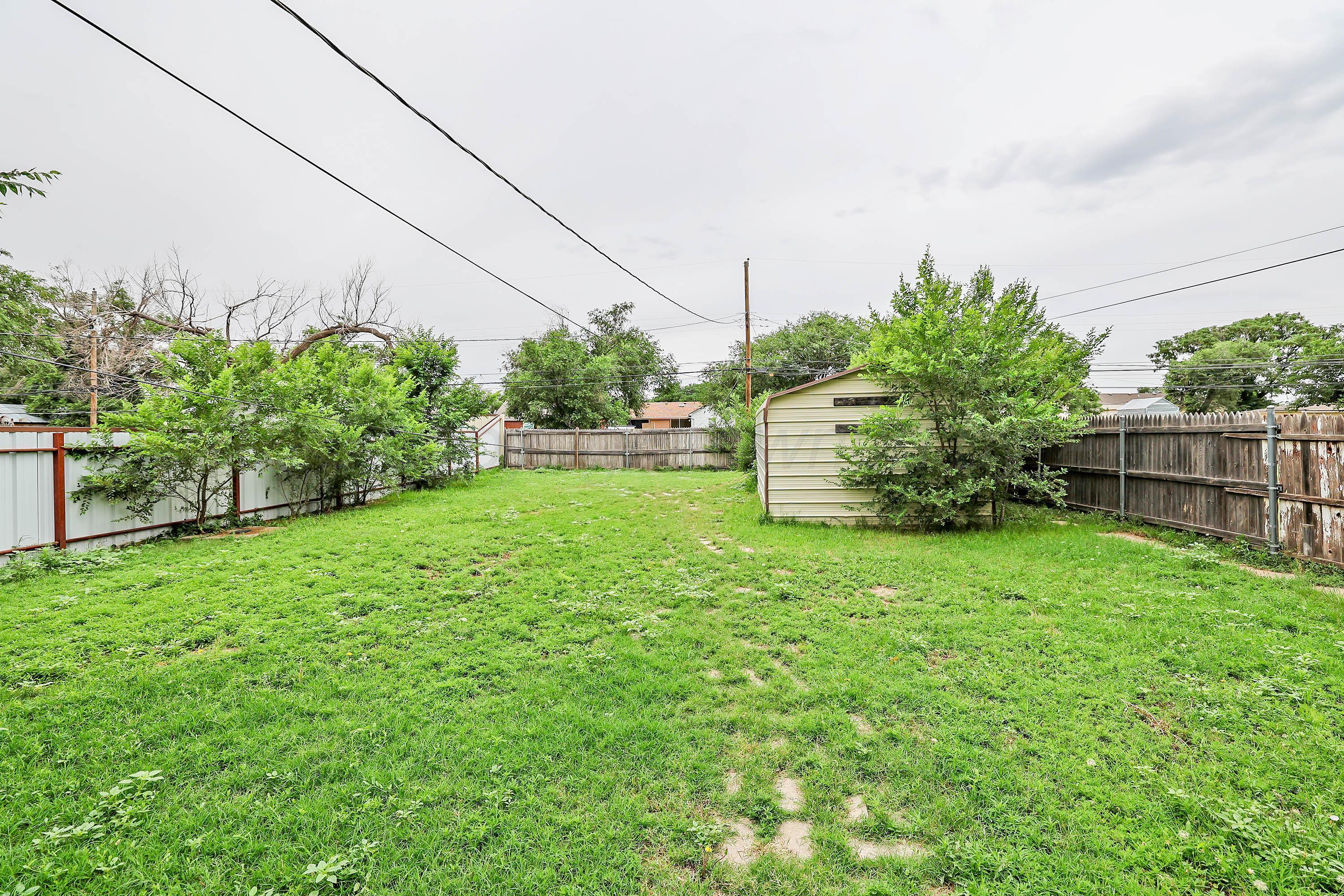 4112 South Tyler Street Amarillo, TX 79110 - Photo 17 of 20 a backyard of a house with lots of green space