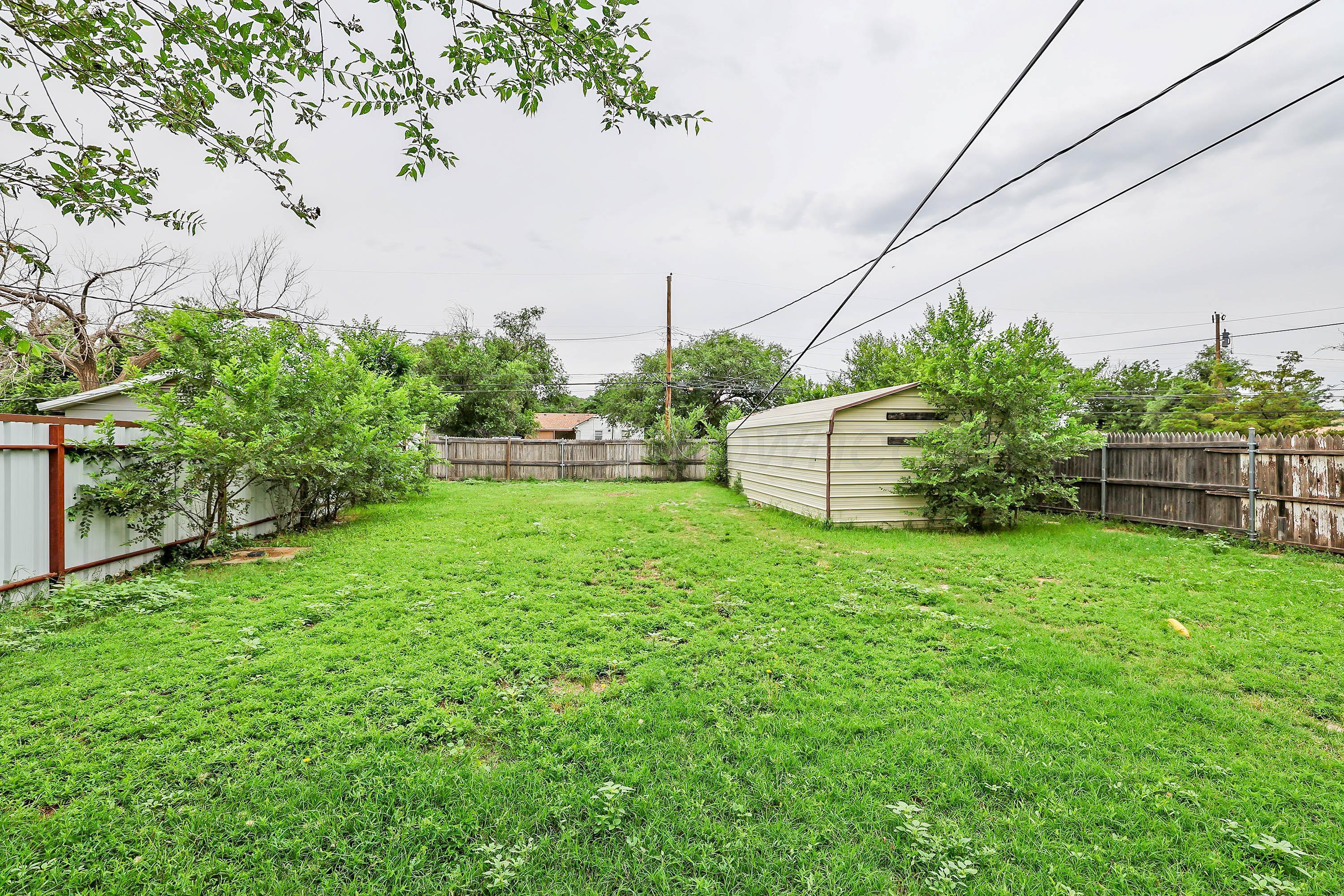 4112 South Tyler Street Amarillo, TX 79110 - Photo 18 of 20 a backyard of a house with lots of green space