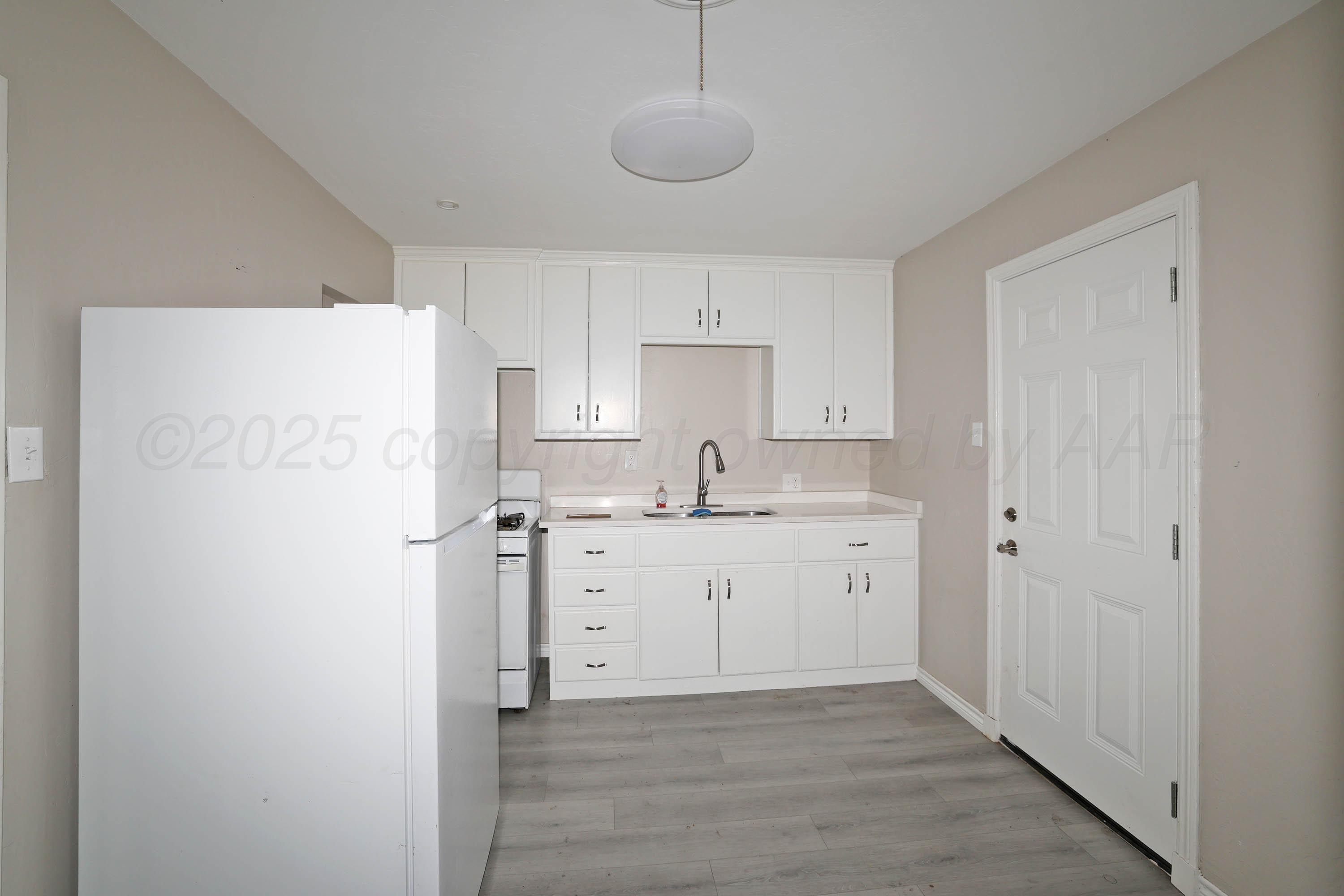 4112 South Tyler Street Amarillo, TX 79110 - Photo 6 of 20 a kitchen with cabinets and stainless steel appliances