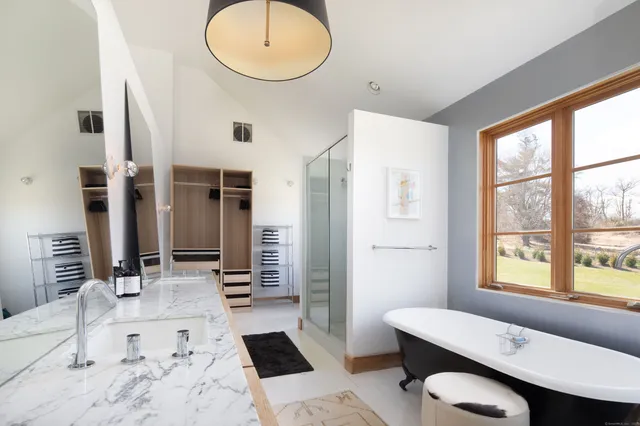 a bathroom with a sink mirror and a bathtub